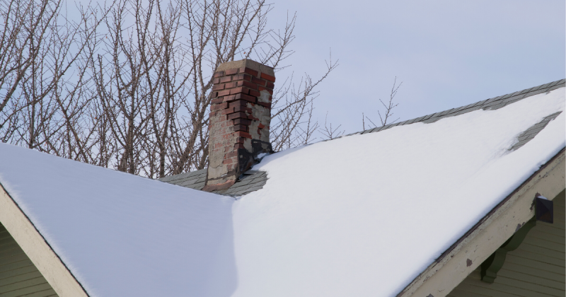 Image of snowy chimney for How To Reduce Your Chimney Sweep Cost in 2022