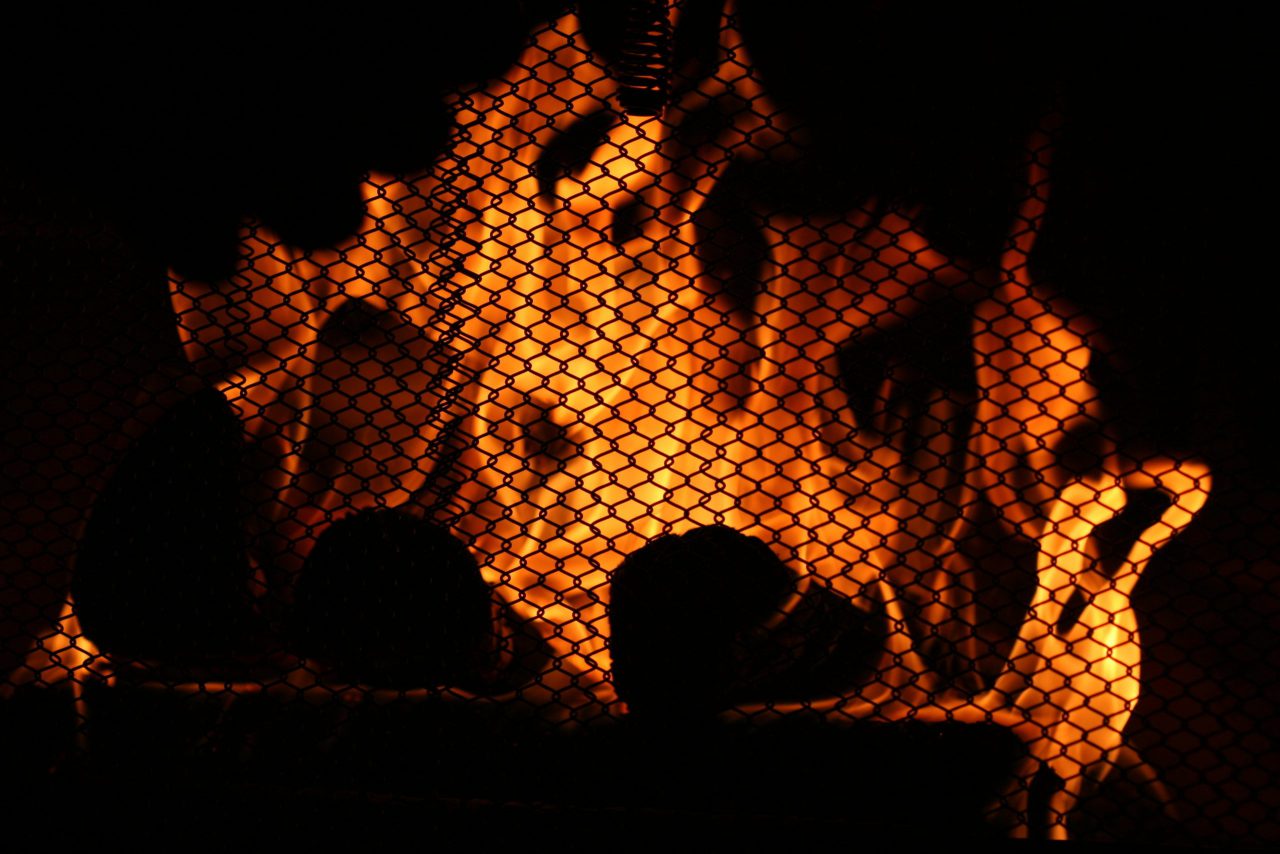 FireplaceWarmthFlamesBurnFuriouslyBehindTheProtectiveFireplaceScreen